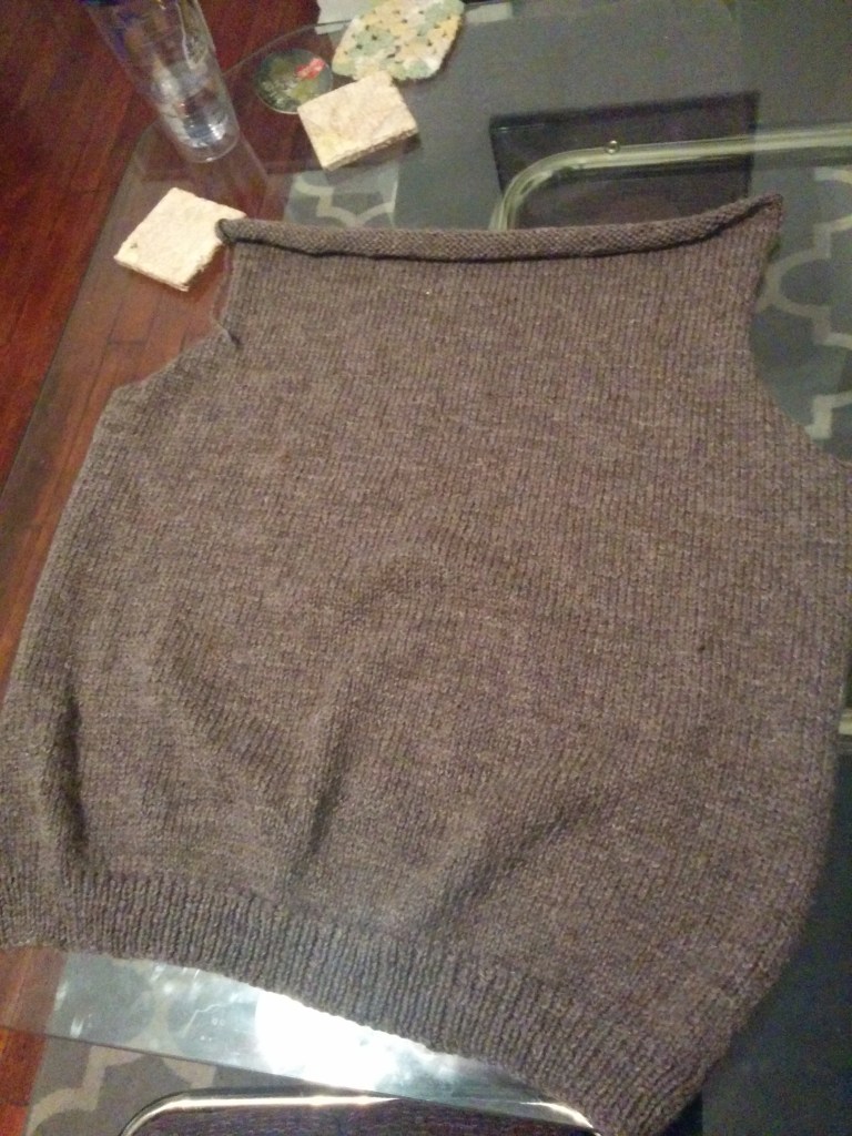The back portion of a hand knit sweater