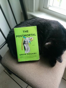 The Postmortal, in paperback, with Bagheera (an avid reader cat)